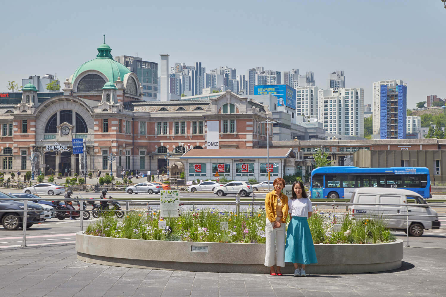 two smiling women; urban garden